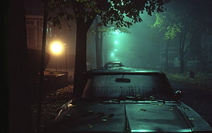 Moody Vintage Car Parked on a Foggy Street at Night with Green Streetlights HD wallpaper