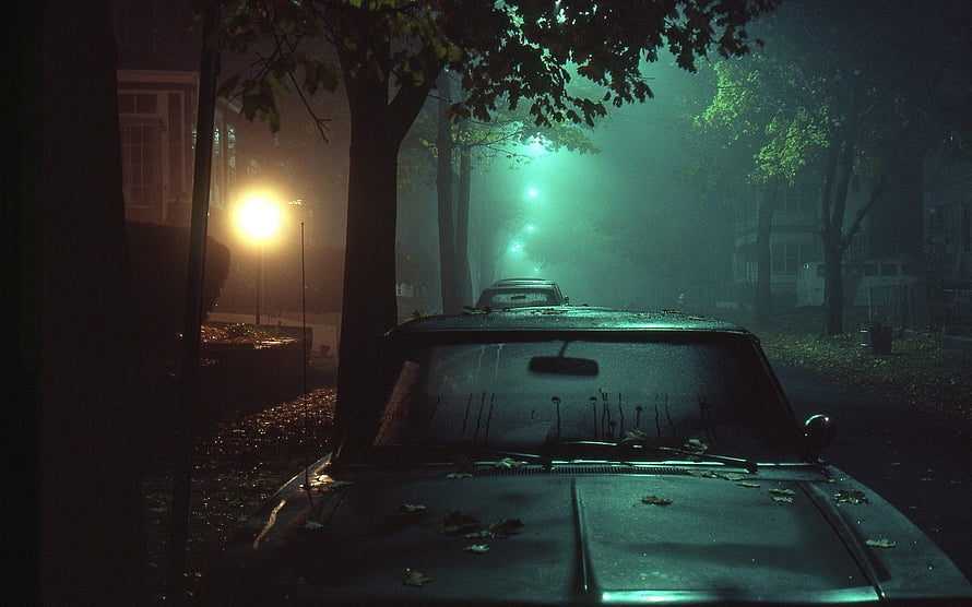 Moody Vintage Car Parked on a Foggy Street at Night with Green Streetlights HD wallpaper