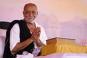 Morari Bapu Seated in White Kurta with Black Shawl and Prayer Hands HD wallpaper