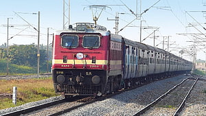 Indian Railways WAP4 Electric Locomotive Pulling Passenger Coaches on Electrified Track HD wallpaper