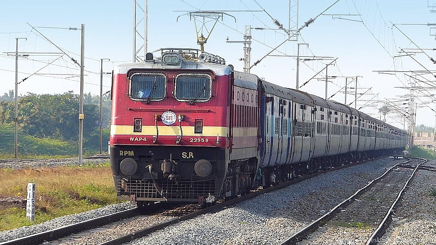 Indian Railways WAP4 Electric Locomotive Pulling Passenger Coaches on Electrified Track HD wallpaper