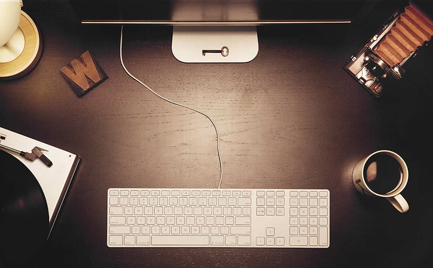 Top-Down View of a Minimalist Workspace with Keyboard, Coffee, and Vintage Camera HD wallpaper