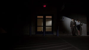Better Call Saul Characters Standing in Dim Parking Garage Under Exit Sign HD wallpaper
