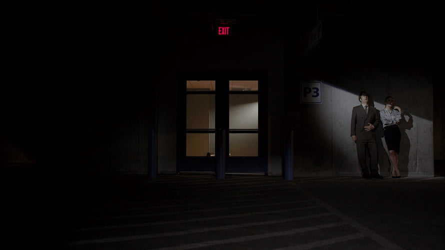 Better Call Saul Characters Standing in Dim Parking Garage Under Exit Sign HD wallpaper