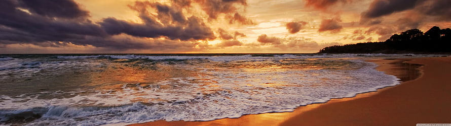 Golden Sunset Over Ocean Waves Lapping on Sandy Beach with Dramatic Clouds HD wallpaper