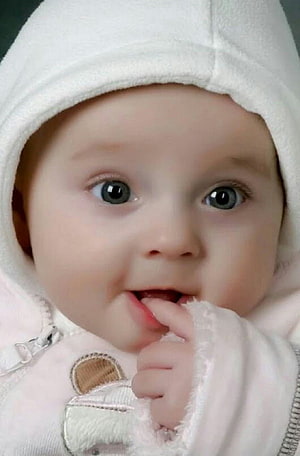 Adorable Baby Boy in White Hooded Outfit with Finger in Mouth HD phone wallpaper