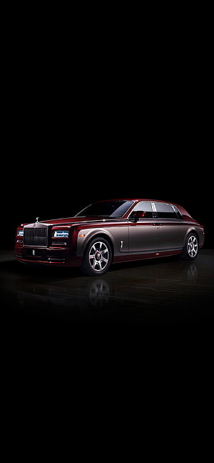 Rolls Royce Phantom luxury sedan in deep red and silver on a dark reflective studio floor HD phone wallpaper
