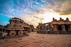 Hampi Temple Complex at Golden Hour with Stone Chariot and Ancient Architecture HD wallpaper