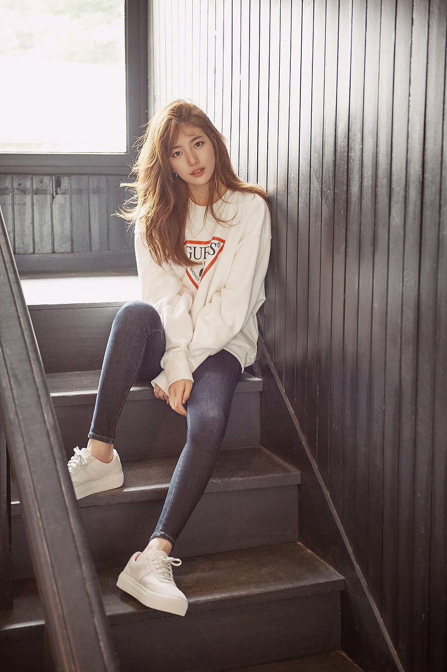 Bae Suzy in White Guf's Sweatshirt and Dark Jeans Sitting on Wooden Staircase HD phone wallpaper