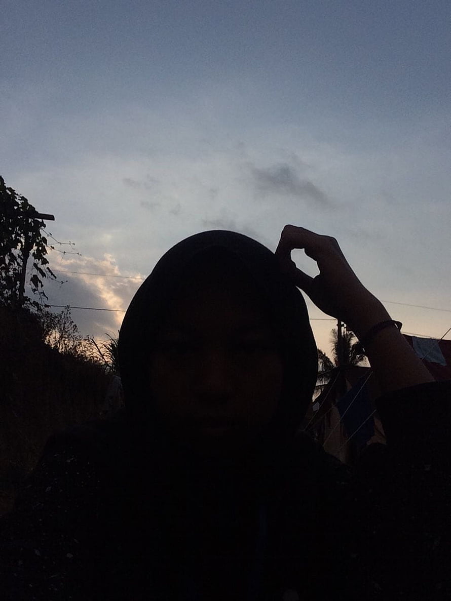 Silhouette of a woman in a hijab against a twilight sky with soft clouds HD phone wallpaper