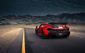 Red McLaren P1 Super Car on Desert Highway Under Dramatic Sky HD wallpaper