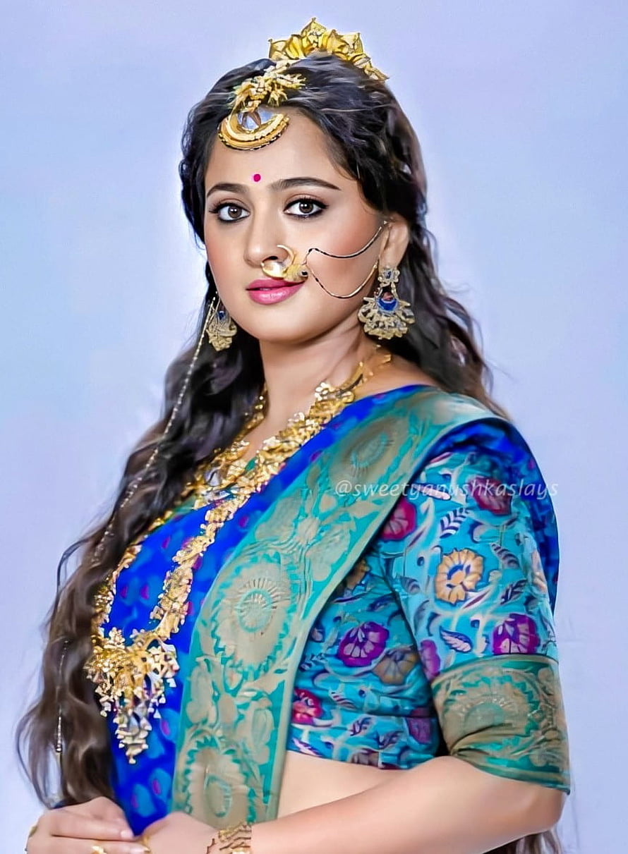 Anushka Shetty in Traditional Indian Saree with Gold Jewelry and Floral Motifs HD phone wallpaper