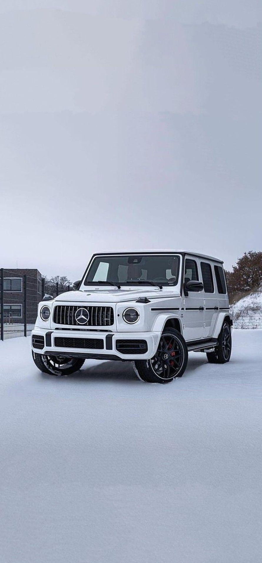 White Mercedes-AMG G-Class SUV parked on a snowy field under an overcast winter sky HD phone wallpaper