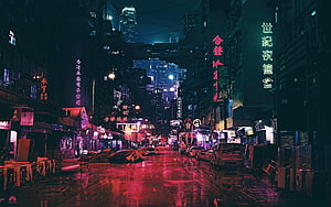 Neon-lit rainy street in a dense Asian cityscape at night with glowing signs and reflections HD wallpaper