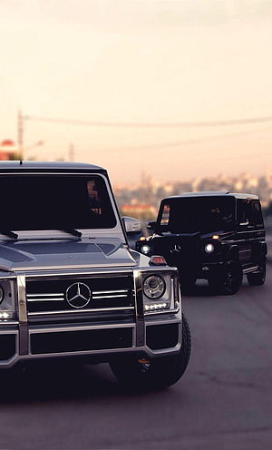 Silver and Black Mercedes G Wagon SUVs Driving on a City Road at Sunset HD phone wallpaper