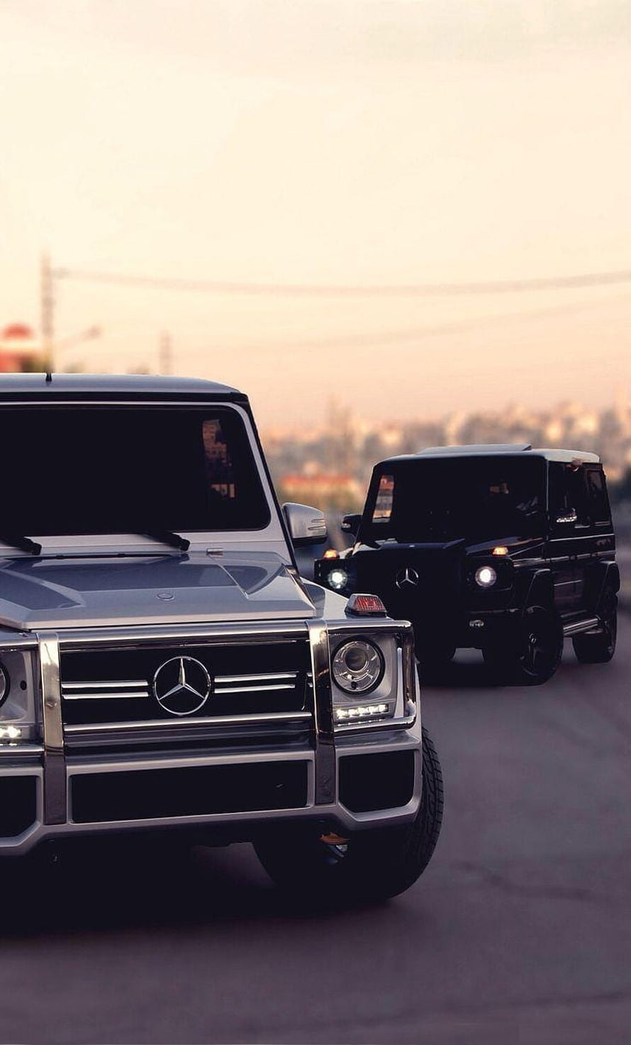 Silver and Black Mercedes G Wagon SUVs Driving on a City Road at Sunset HD phone wallpaper