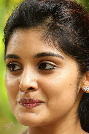 Nivetha Thomas Close-Up Portrait With Diamond Stud Earring And Soft Green Background HD phone wallpaper