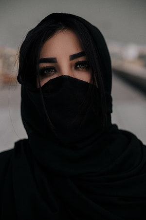 Portrait of a woman wearing a black hijab and face veil with a moody, cinematic aesthetic HD phone wallpaper