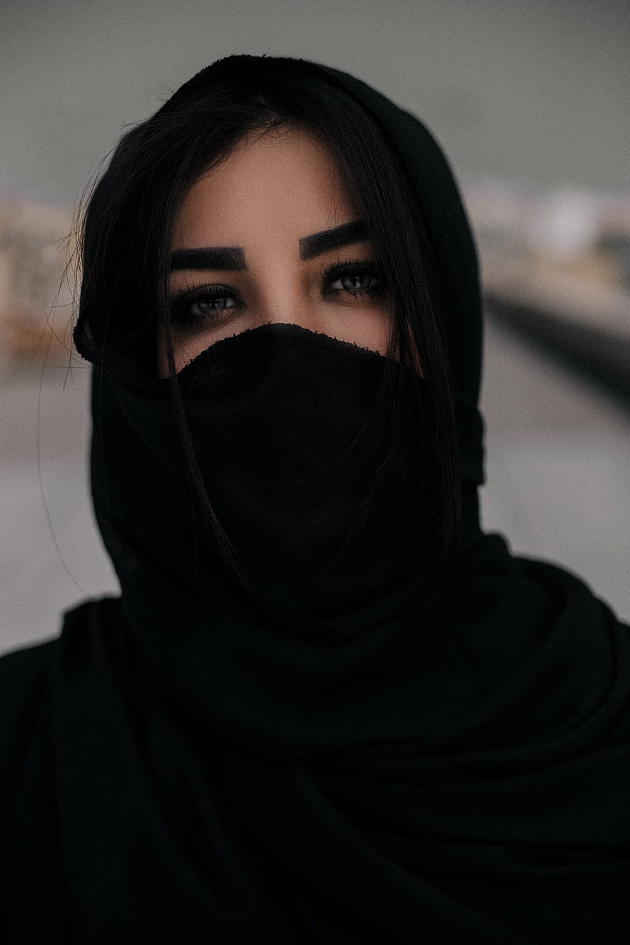 Portrait of a woman wearing a black hijab and face veil with a moody, cinematic aesthetic HD phone wallpaper