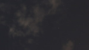 Dark Starry Night Sky with Faint Clouds and Scattered Stars HD wallpaper