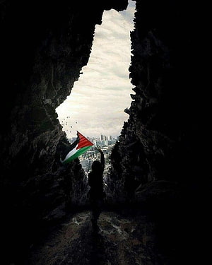 Silhouette of a person holding a Palestinian flag in a rocky cave opening overlooking a city skyline HD phone wallpaper