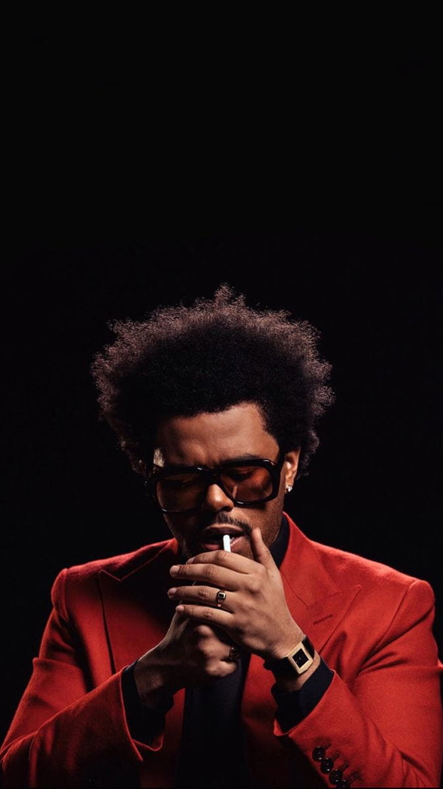 The Weeknd in a red suit and dark sunglasses smoking a cigarette against a black background HD phone wallpaper