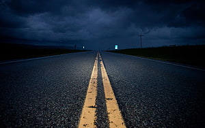 Empty Highway Stretching Into Dark Stormy Horizon Under Heavy Clouds HD wallpaper
