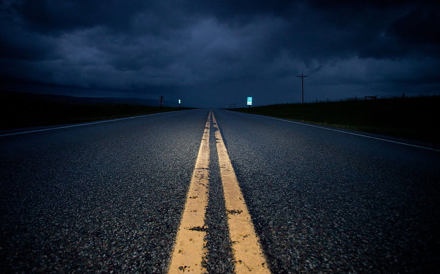Empty Highway Stretching Into Dark Stormy Horizon Under Heavy Clouds HD wallpaper