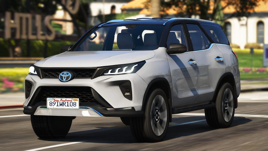 White Toyota Fortuner SUV Driving on a Suburban Street HD wallpaper