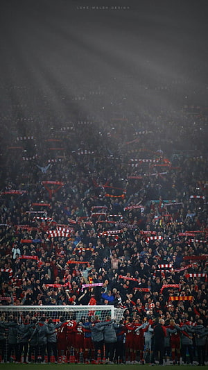 Liverpool FC players celebrating with Anfield crowd under dramatic stadium lights HD phone wallpaper