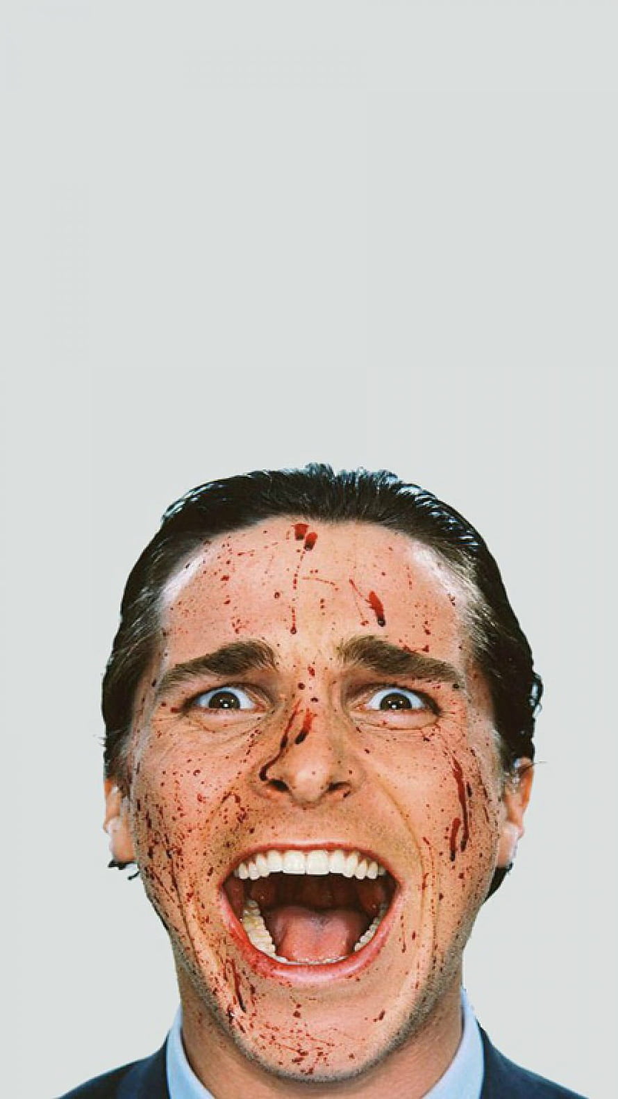 Patrick Bateman from American Psycho with blood-splattered face and wide open mouth HD phone wallpaper