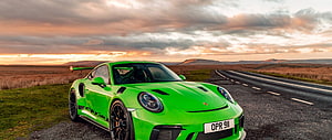 Vibrant Green Porsche 911 GT3 RS Parked on a Scenic Country Road at Sunset HD wallpaper