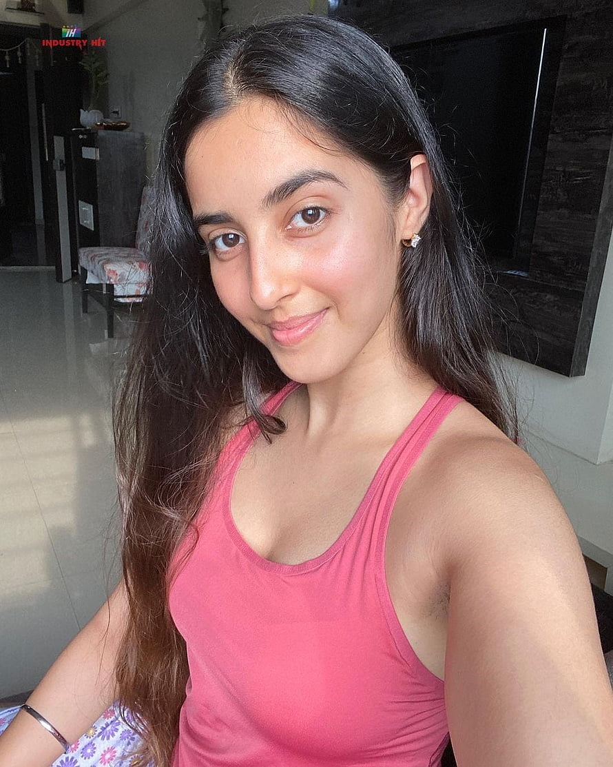 Simrat Kaur Randhawa in a pink tank top with long dark hair in a casual indoor setting HD phone wallpaper