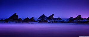 Misty Coastal Rocks at Twilight with Purple and Blue Sky HD wallpaper