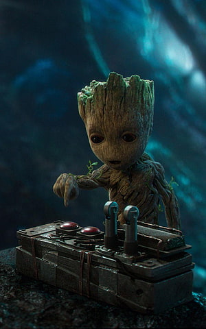 Baby Groot Reaching for a Sci-Fi Control Panel in a Dark Cavern HD phone wallpaper