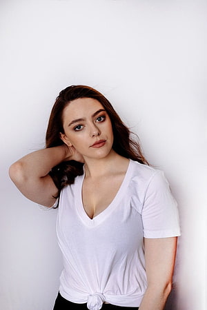 Danielle Rose Russell in a White Knotted V-Neck T-Shirt Against a White Background HD phone wallpaper