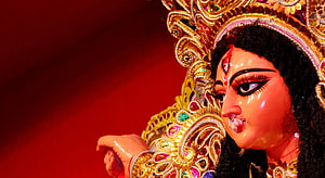Maa Durga ornate golden headdress and traditional Indian deity statue close-up HD wallpaper