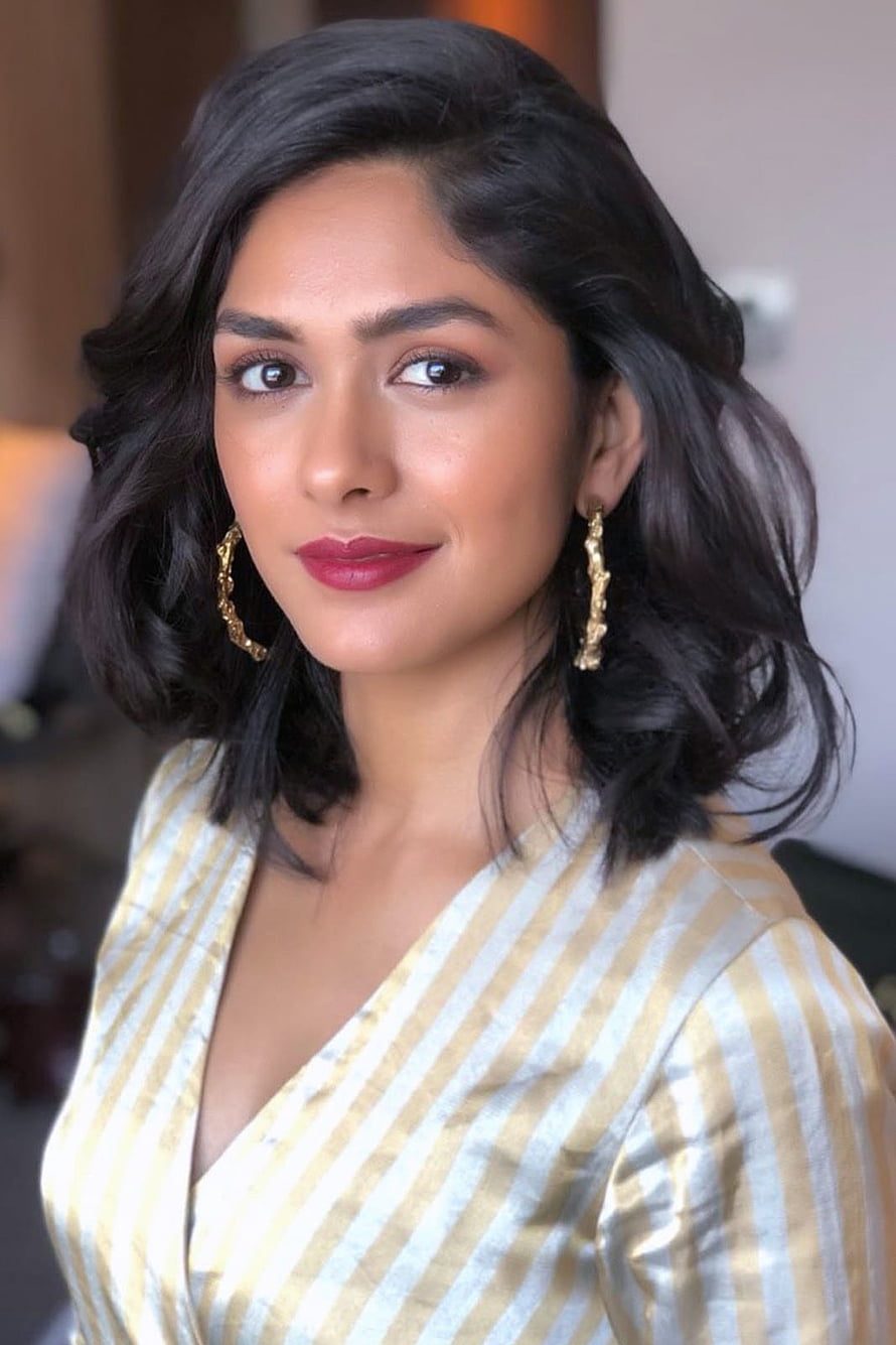 Mrunal Thakur in a Gold and White Striped Blazer with Elegant Gold Earrings HD phone wallpaper