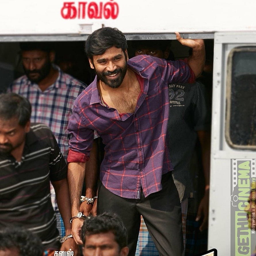 Dhanush in Vada Chennai movie still, smiling in a purple plaid shirt stepping out of a vehicle HD phone wallpaper