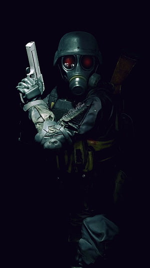 Hunk from Resident Evil in tactical gear with gas mask and pistol in dark setting HD phone wallpaper