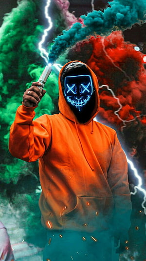Alan Oviedo in Orange Hoodie Wearing Glowing LED Mask with Colorful Smoke and Lightning HD phone wallpaper