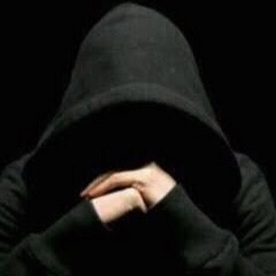 Mysterious Hooded Figure with Hands Covering Face in Dark Atmosphere HD phone wallpaper