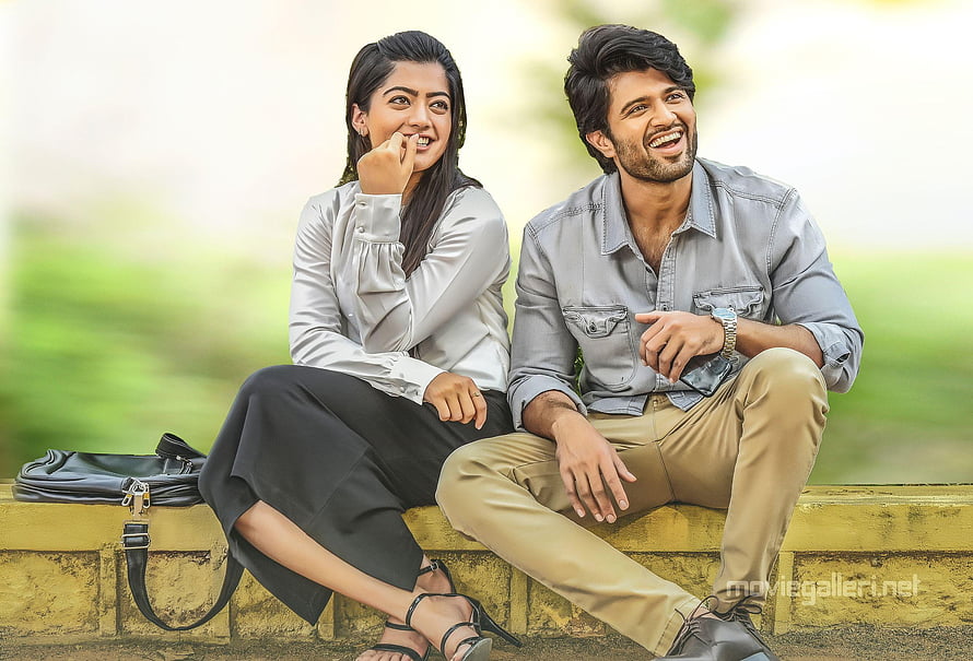 Geetha Govindam Movie Still: Smiling Couple Sitting on a Yellow Wall Outdoors HD wallpaper
