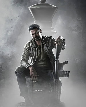 Prabhas as Salaar in a moody monochrome portrait with rifle and chess piece HD phone wallpaper