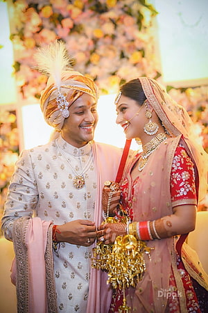 Traditional Indian Wedding Couple in Elegant Attire Sharing a Joyful Moment HD phone wallpaper
