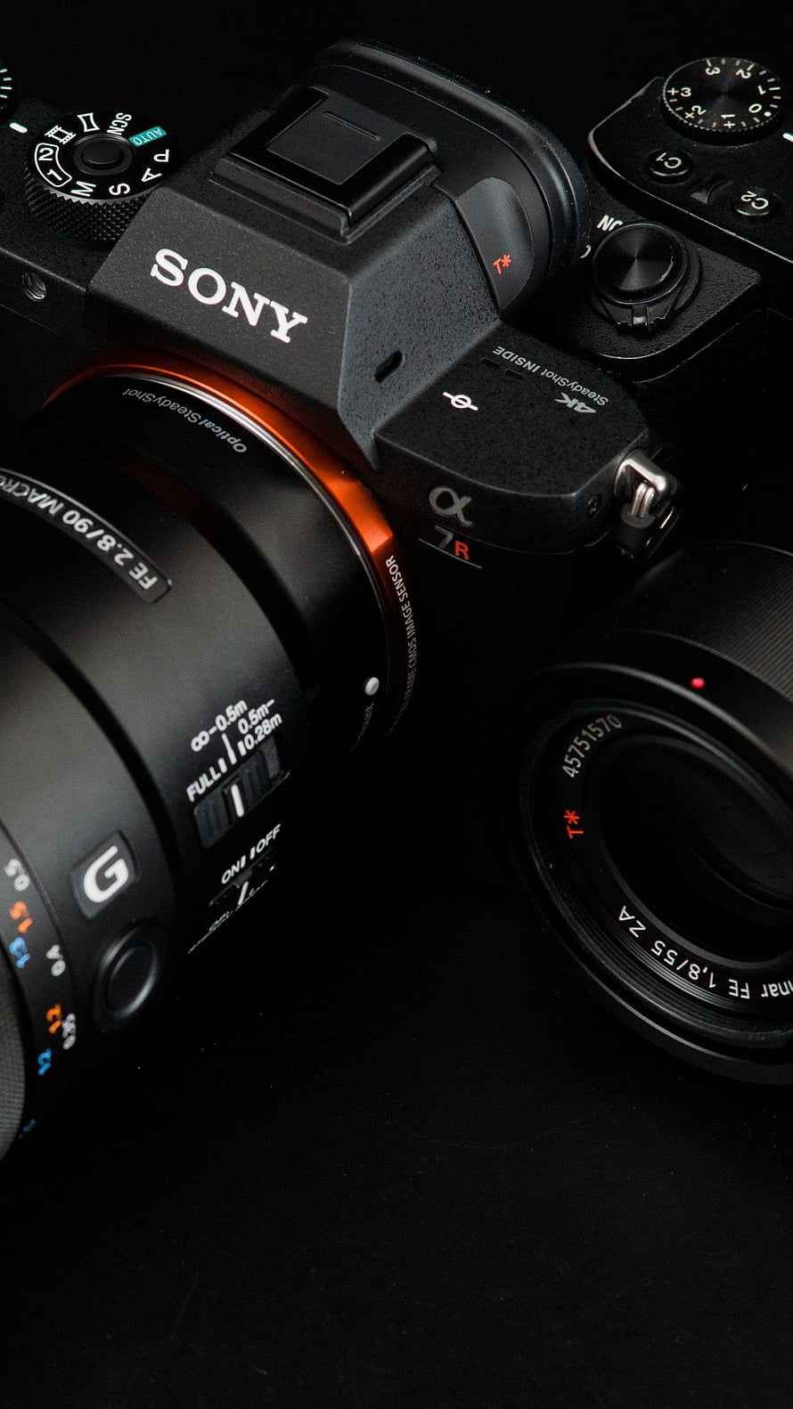 Sony Alpha 7R Mirrorless Camera with G Lens Close-Up on Black Background HD phone wallpaper