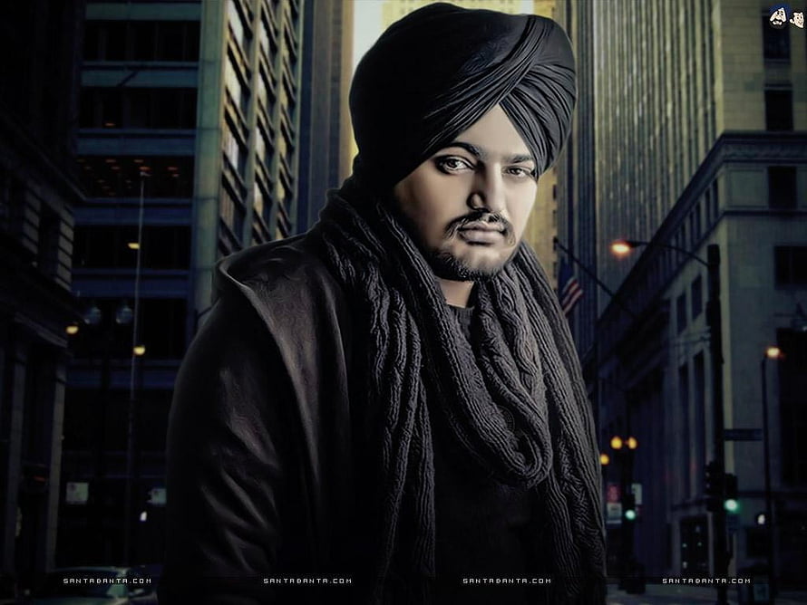 Sidhu Moose Wala Portrait in Black Turban and Scarf Against Urban Cityscape HD wallpaper