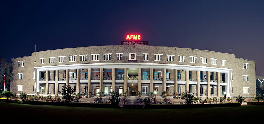 Armed Forces Medical College Pune Main Building at Night with Illuminated AFMC Signage HD wallpaper