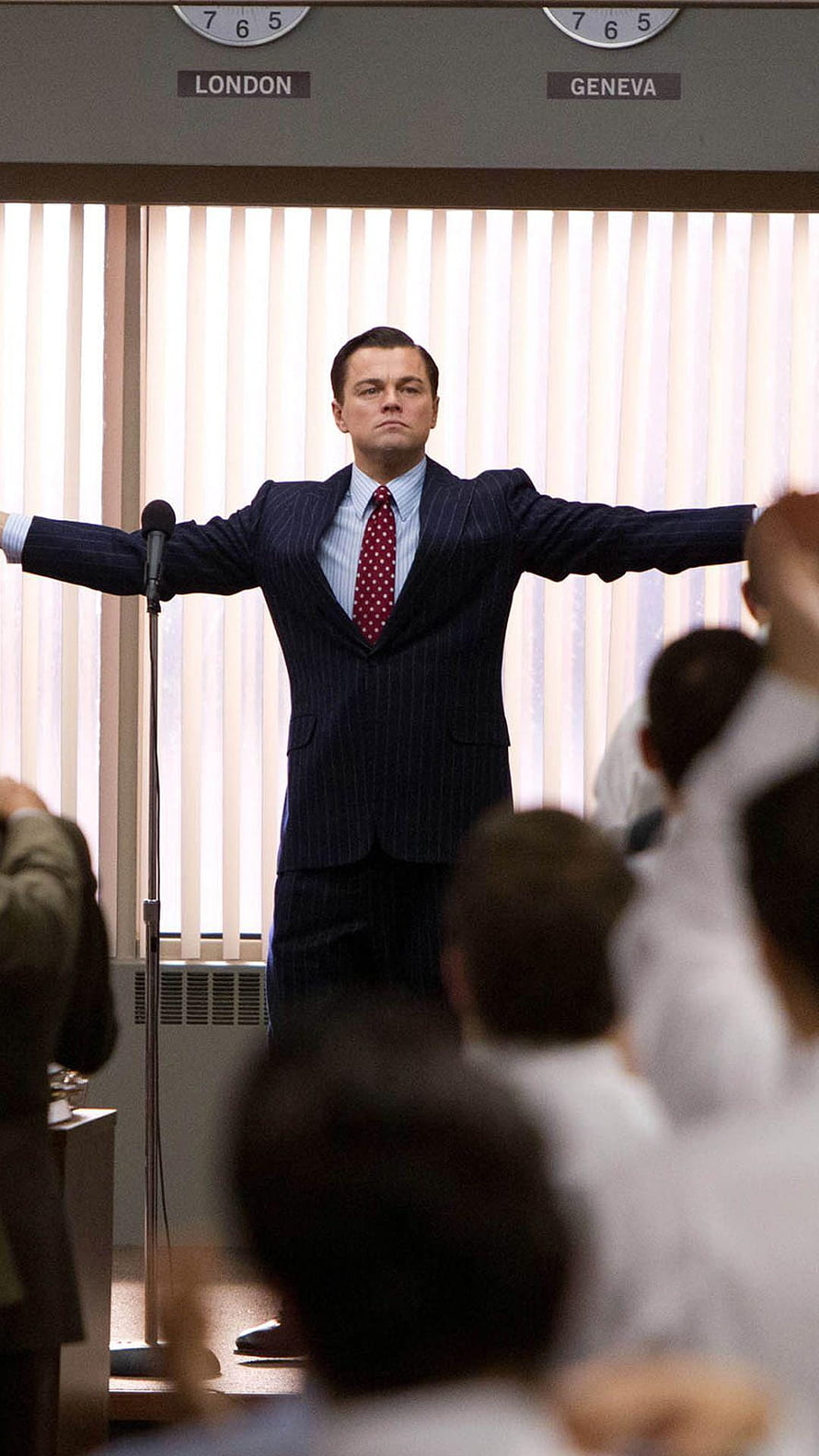 Leonardo DiCaprio in The Wolf of Wall Street standing with arms outstretched before a crowd HD phone wallpaper