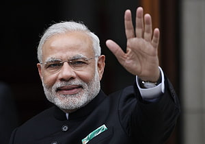Narendra Modi Waving in Black Bandhgala with Green Pocket Square HD wallpaper